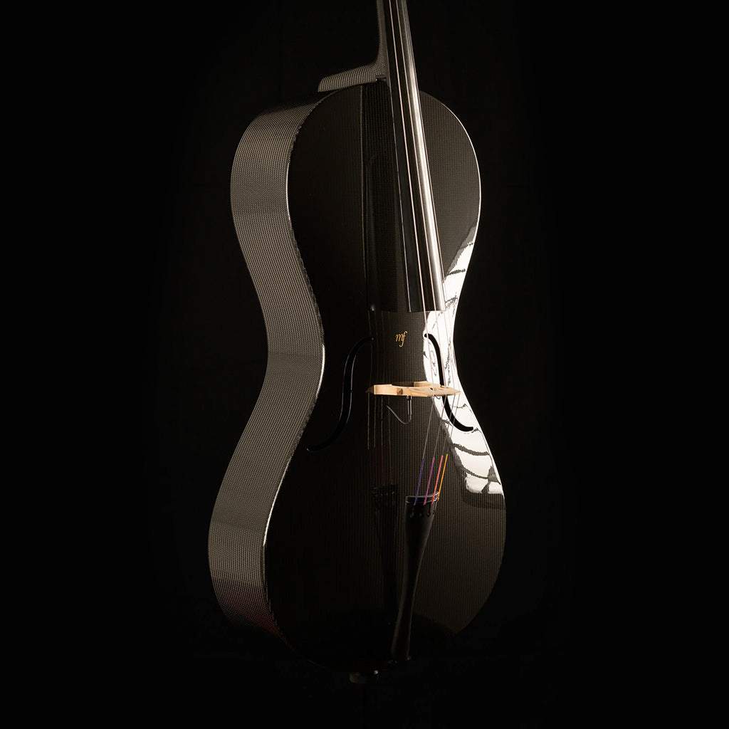 Three-quarter view of a Mezzo-Forte carbon fiber cello from the left, with light reflecting off the glossy top and woven ribs, on a black background.