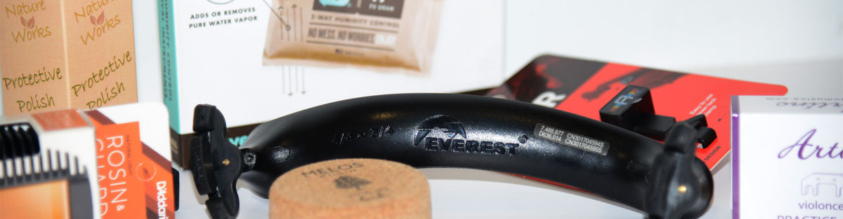 assortment of accessories for viola, including everest shoulder rest, rosin, protective polish, and practice mute