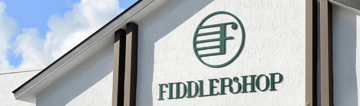 Fiddlershop storefront sign with blue sky behind