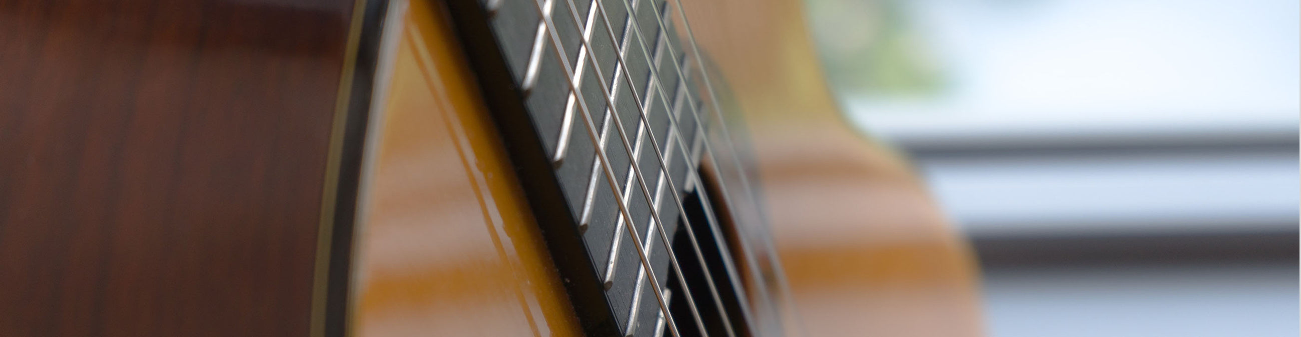 Close up photo of a classical guitar with nylon guitar strings