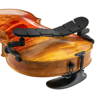 Violin with a black shoulder rest on a white background