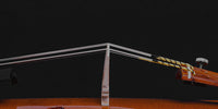 Close up photo if violin bridge in profile.